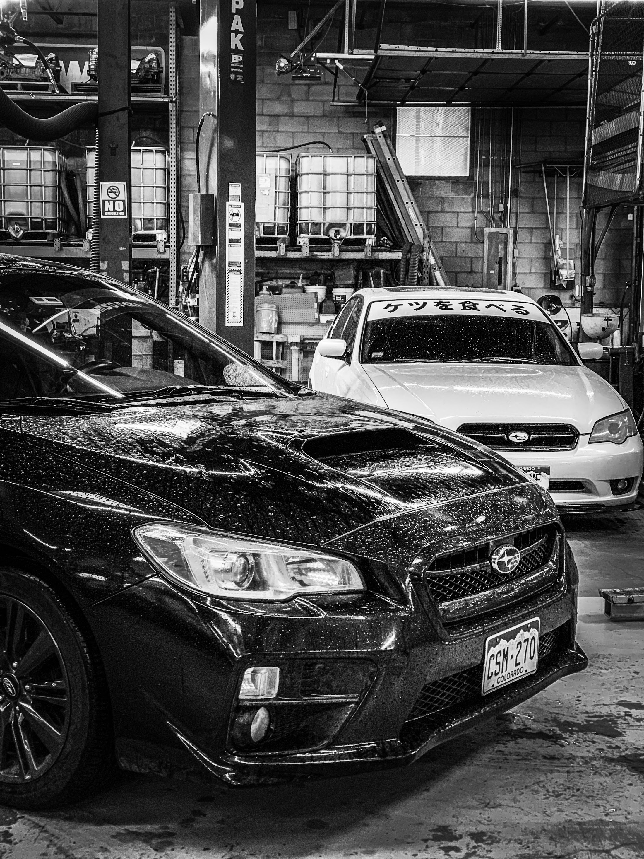 Subaru vehicles inside Strictly Automotive repair shop